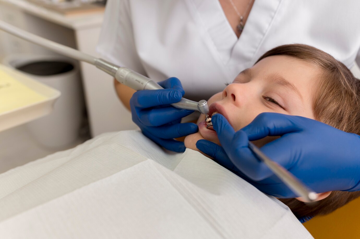 dentist-cleaning-child-s-teeth_23-2149195881